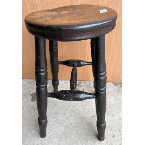 9 - A 19thC beech stool with circular top and turned legs. 54cm h.