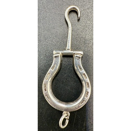 20 - A hallmarked silver folding horseshoe button hook on suspension ring. Length 5cm. Birmingham 1903.