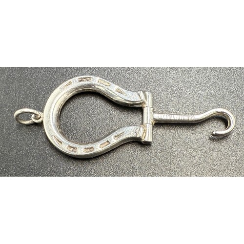 20 - A hallmarked silver folding horseshoe button hook on suspension ring. Length 5cm. Birmingham 1903.