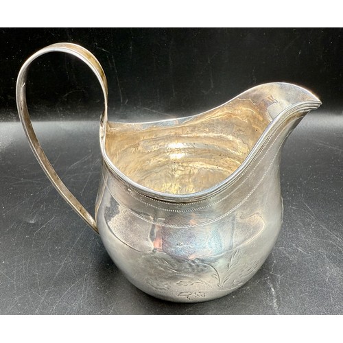 53 - A Georgian silver helmet shaped cream jug. Weight 91gm.