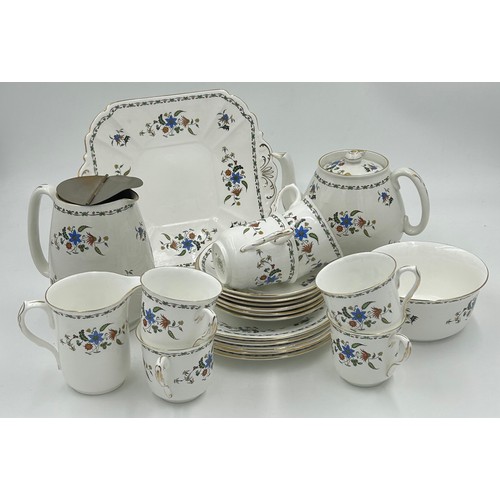 214 - A Shelley Chelsea pattern tea service to include a square cake plate, a teapot with stand, a lidded ... 