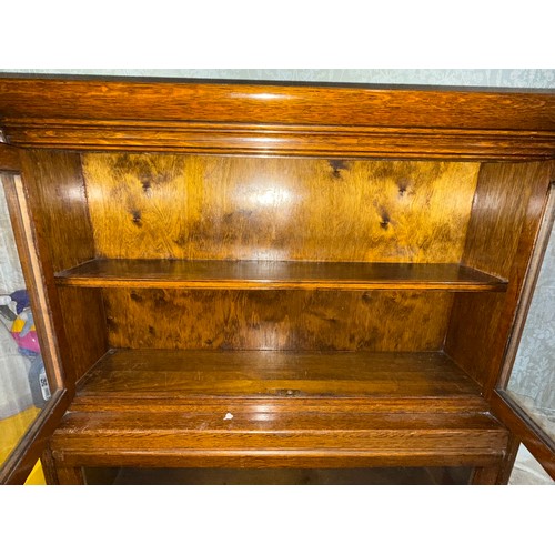 58 - A Globe Wernicke style oak bookcase, in two sections, the upper section with glazed cupboard, the lo... 