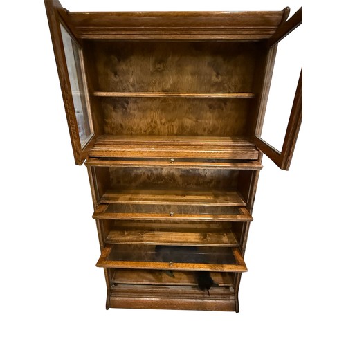 58 - A Globe Wernicke style oak bookcase, in two sections, the upper section with glazed cupboard, the lo... 