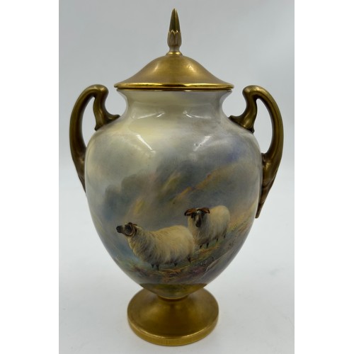 Harry Davis for Royal Worcester : A hand painted twin handled vase with gilded cover, gilded circular foot depicting horned sheep on mountain landscape, 21cm to top of lid, signed to the right, maker mark to base in puce shape number 2701.