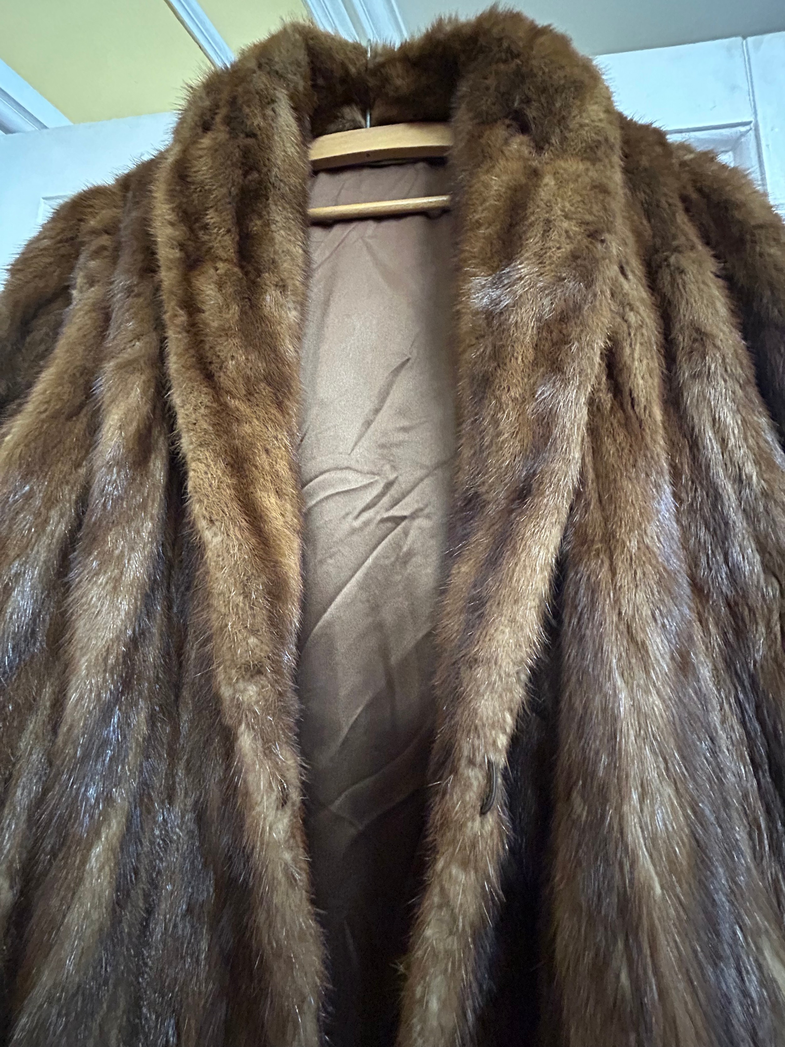 A vintage Musquash fur coat with long wide sleeves, two pockets lined ...
