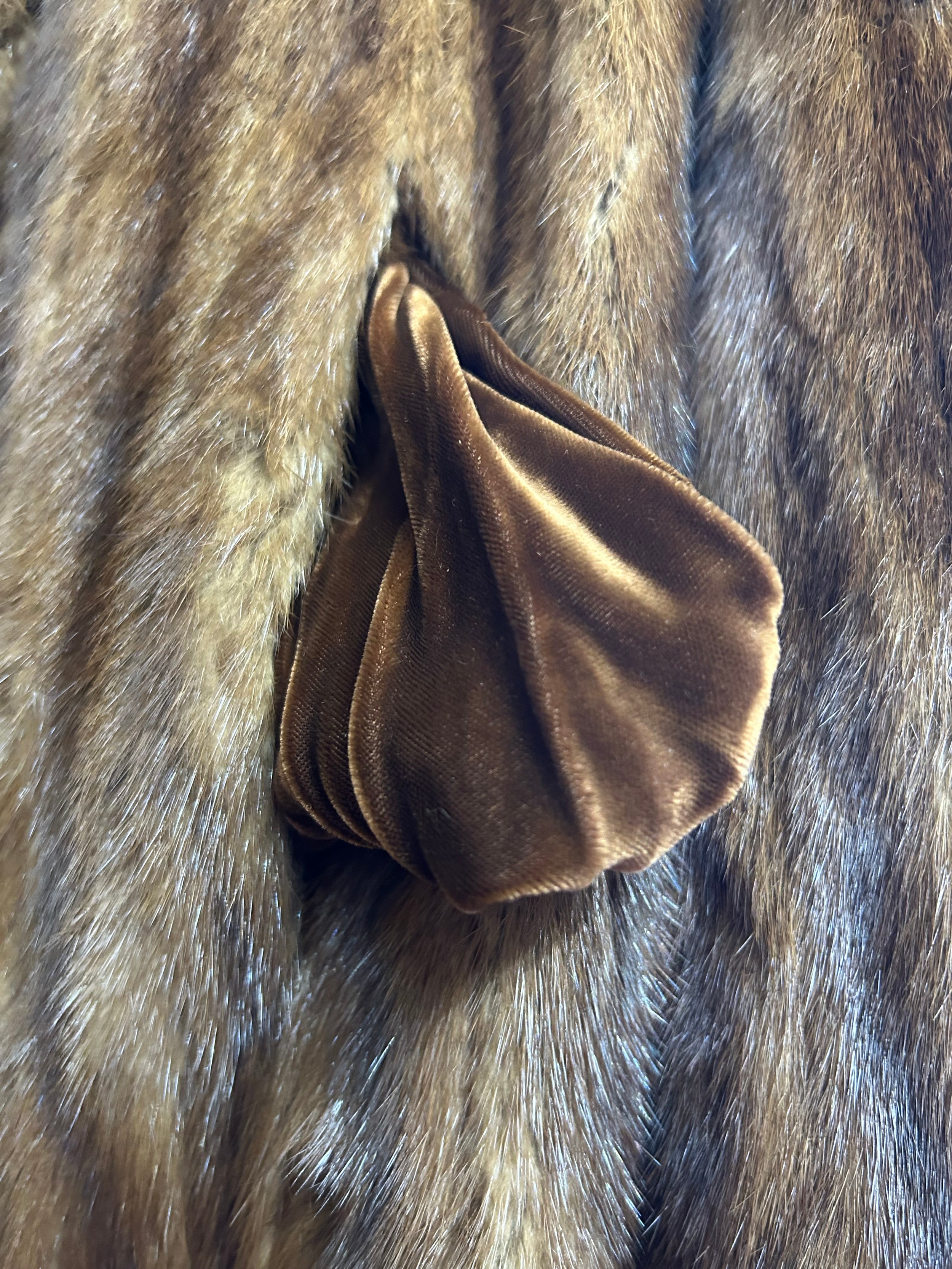 A vintage Musquash fur coat with long wide sleeves, two pockets lined ...