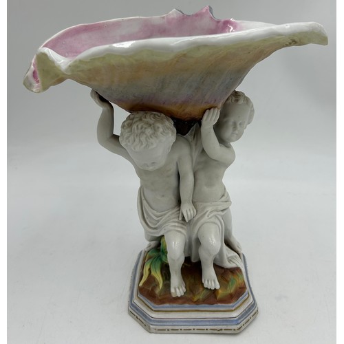 230 - A 19thC hand painted cherub bisque centrepiece with two putti and seashell together with 2 x hand pa... 
