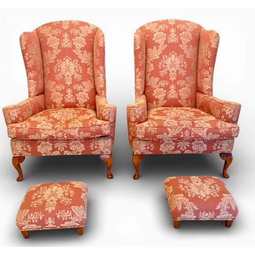 58 - A pair of wing backed armchairs and matching footstools. 119cm h to back 89cm w.