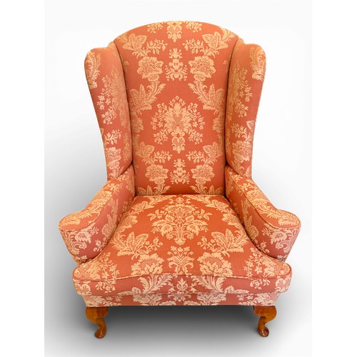 58 - A pair of wing backed armchairs and matching footstools. 119cm h to back 89cm w.