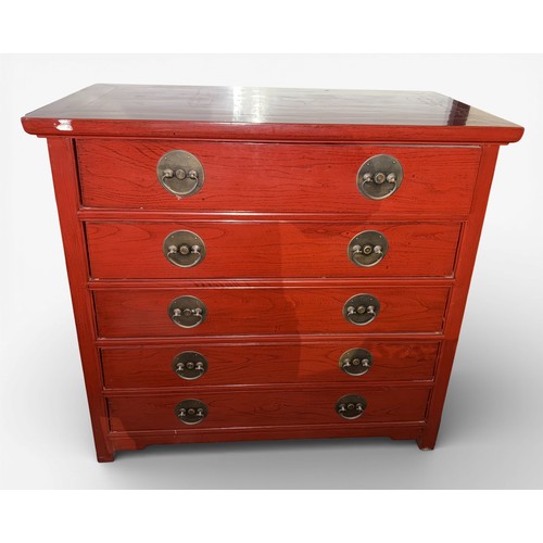 80 - A red lacquer oriental chest of five drawers with brass handles. Graduating in width from top to bot... 