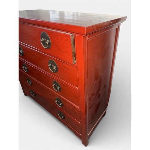 80 - A red lacquer oriental chest of five drawers with brass handles. Graduating in width from top to bot... 