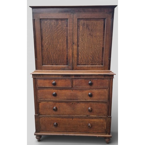 86 - A 19thC oak and cross banded linen press. 208cm h x 124cm w x 57cm d.