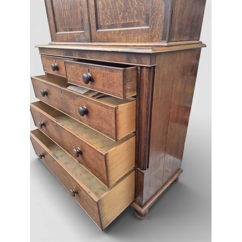 86 - A 19thC oak and cross banded linen press. 208cm h x 124cm w x 57cm d.