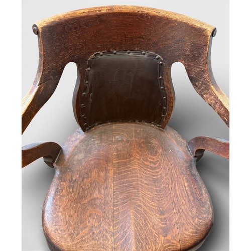 99 - An oak captains chair with cabriole legs and upholstered back.