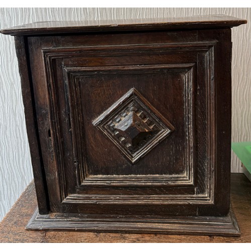 107 - An oak cupboard with single door. 37cm w x 21cm d x 38cm h.