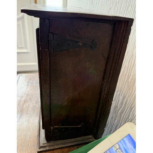 107 - An oak cupboard with single door. 37cm w x 21cm d x 38cm h.
