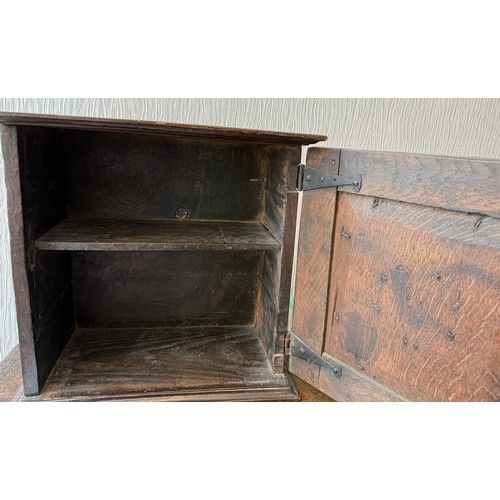 107 - An oak cupboard with single door. 37cm w x 21cm d x 38cm h.