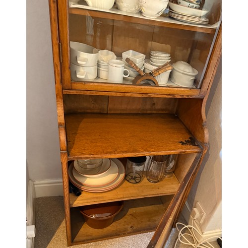 108 - An oak cabinet with glazed top and solid door to base. 203cm h x 63cm w x 36cm d.
