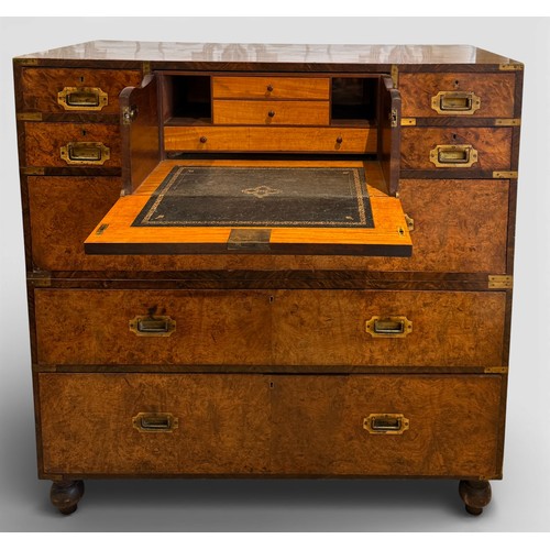 115 - A burr walnut and mahogany campaign chest on turned feet with full brass fittings and secretaire dra...