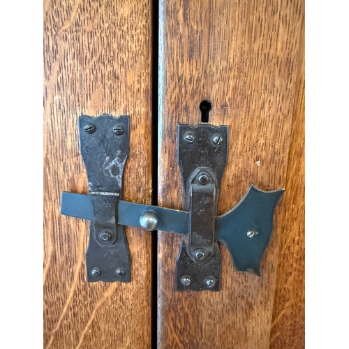116 - An oak Arts and Craft style single door cupboard with shelving to the interior. 189cm h x 99cm w x 3... 