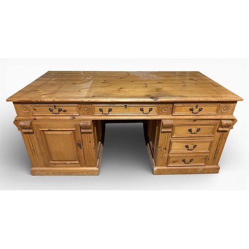 132 - A pine pedestal kneehole desk. 185cm w x 90cm d x 80cm h.