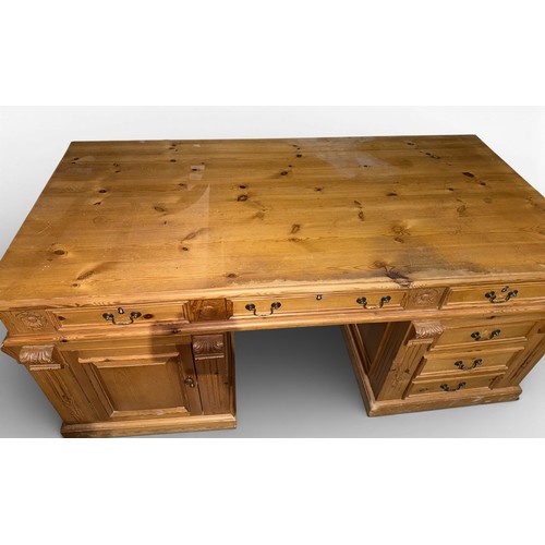 132 - A pine pedestal kneehole desk. 185cm w x 90cm d x 80cm h.