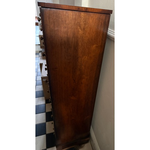 139 - A 19thC rosewood veneered chest of 12 drawers with brass knobs. 121 h  x 42 w x32cm d.