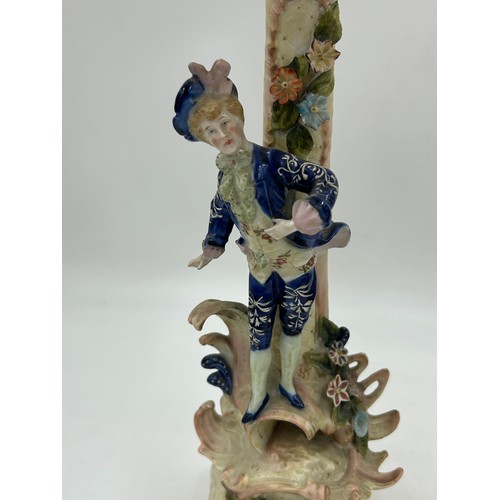 418 - A pair of ornate porcelain figural four branch candelabras in the Dresden style. 47cm h.