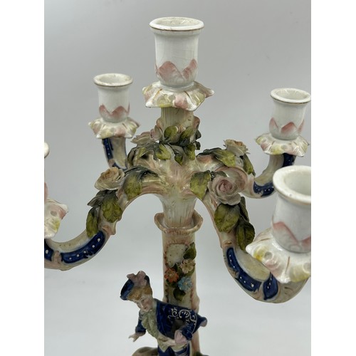 418 - A pair of ornate porcelain figural four branch candelabras in the Dresden style. 47cm h.