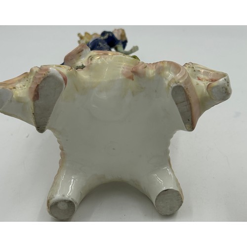 418 - A pair of ornate porcelain figural four branch candelabras in the Dresden style. 47cm h.