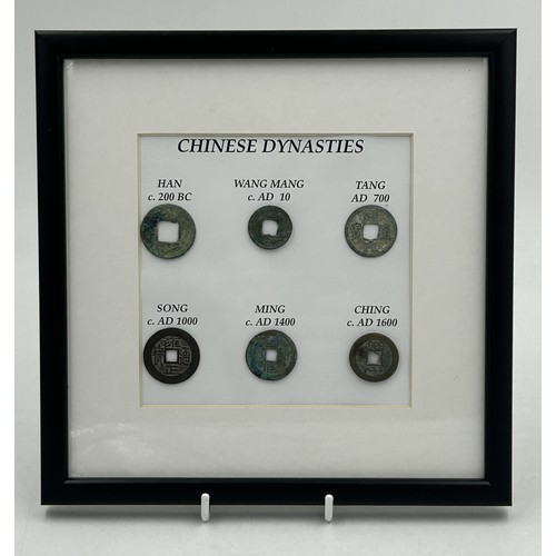 A framed collection of Chinese coins representing 6 different dynasties.