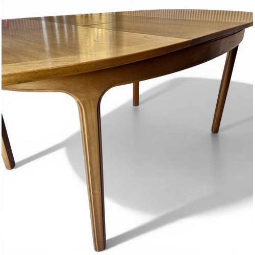 14 - A mid 20thC teak Nathan extending dining table and four Parker Knoll chairs. 206cm l extended, 152cm... 