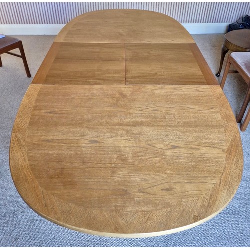 14 - A mid 20thC teak Nathan extending dining table and four Parker Knoll chairs. 206cm l extended, 152cm... 