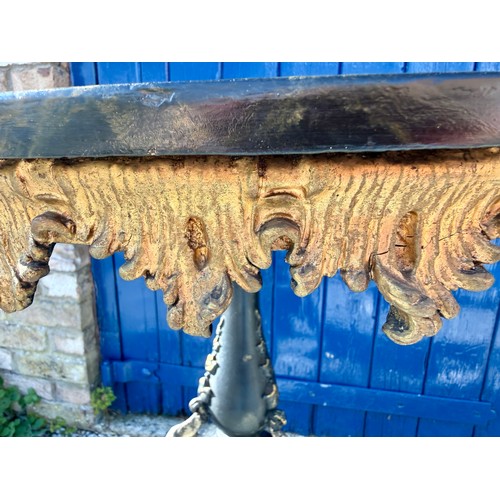 20 - A 19thC tilt top occasional table with painted marbled circular top on black and gilt decorative tri... 