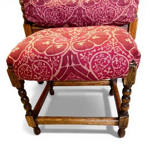22 - Oak framed armchair, 63.5cm w arm to arm and matching footstool with bobbin turnings.