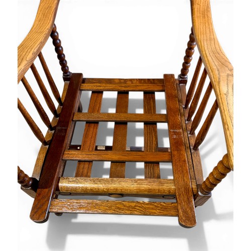 22 - Oak framed armchair, 63.5cm w arm to arm and matching footstool with bobbin turnings.