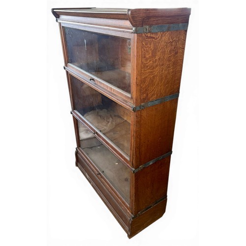 27 - A three height oak Inglesants sectional bookcase. 87cm w x 31cm d x 130cm h.