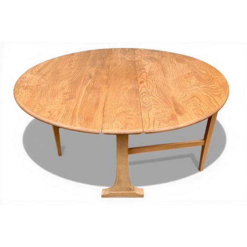 35 - An Ercol circular dining table, circa 1981, 141cm x 125cm.