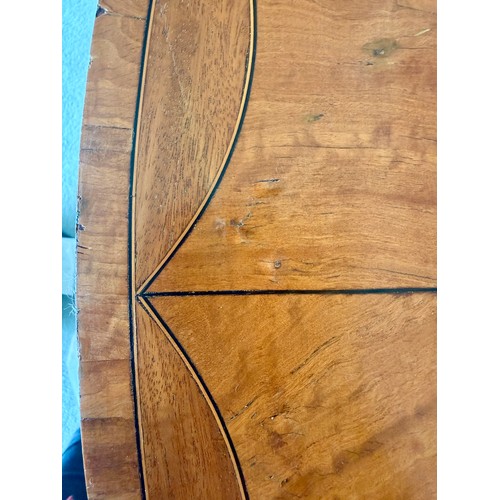 54 - An Edwardian oval satinwood side table. 74 w x 48 d x 71cm h.