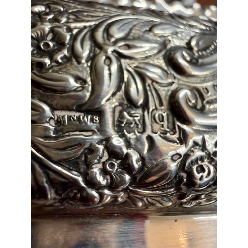 497 - Hallmarked silver lidded box with repoussé decoration and vacant cartouche, the interior with three ... 