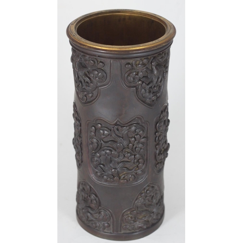 52 - A good quality Chinese bronze vase of cylindrical form, the sides decorated with relief moulded flor...