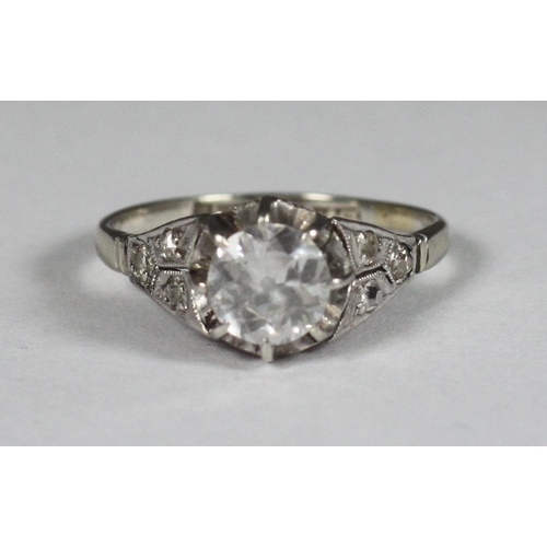 107 - A platinum diamond ring, centrally claw set with a round, transitional cut diamond, total diamond we... 