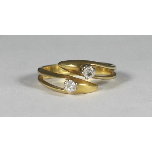 108 - An 18ct gold crossover design ring, the top set with two diamonds, approx. total diamond weight 0.20... 