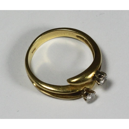 108 - An 18ct gold crossover design ring, the top set with two diamonds, approx. total diamond weight 0.20... 