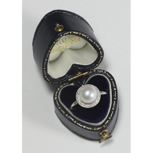 110 - WITHDRAWN  A 9k white gold ring centrally-set with a single pearl surrounded by 33 small diamonds, 2... 