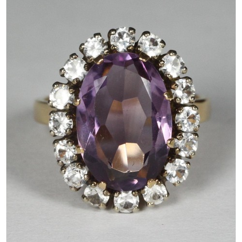 113 - An 18k gold dress ring, eight-claw-set with an oval faceted amethyst coloured stone, approx 14x10mm,... 