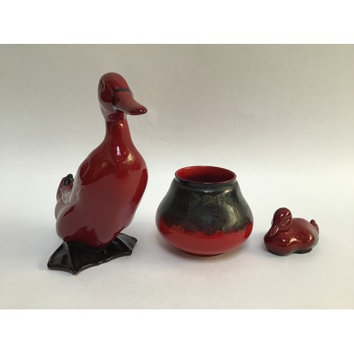 52 - A Royal Doulton Flambe pottery model of a duck, 16cm high, together with a Doulton Flambe duckling a... 