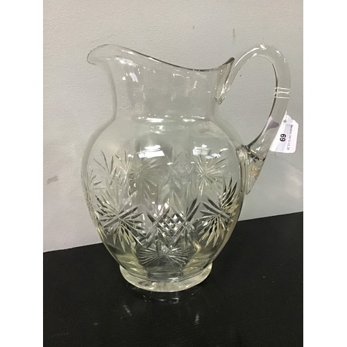 69 - A oversize cut-glass water jug, 30cm high