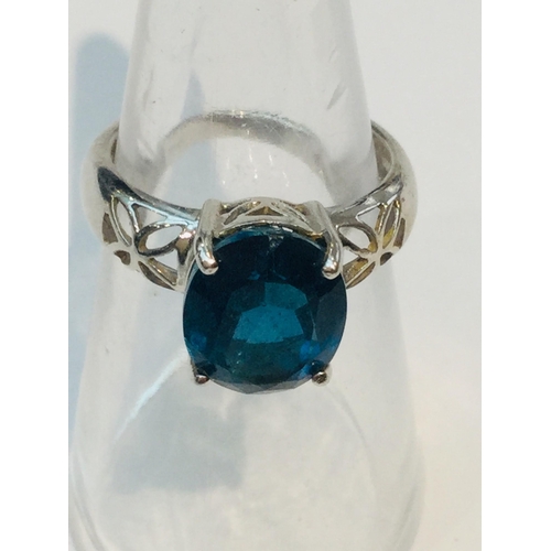 185 - A 9ct white gold set with a round blue topaz stone, measuring 8x8mm, ring weighs 5.2 grams, finger s... 