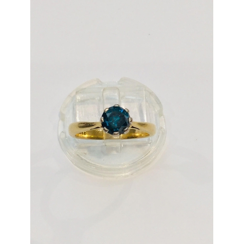 187 - An 18ct yellow gold solitaire blue diamond ring, the round diamond is set in eight platinum claws, e... 